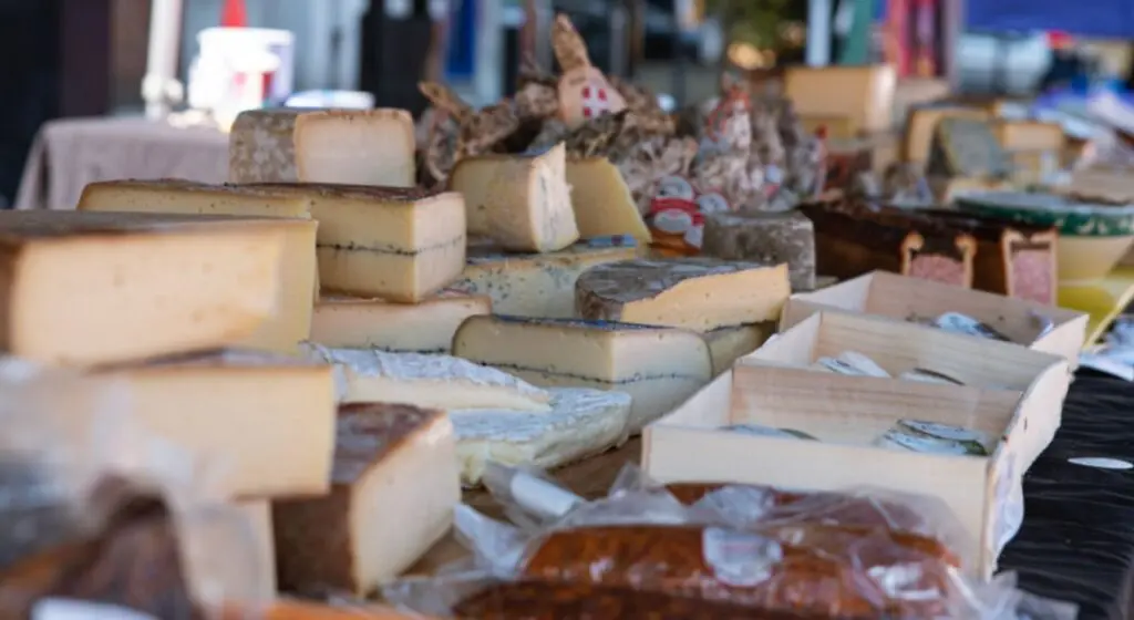 Selection of cheeses and charcuterie on a market stall